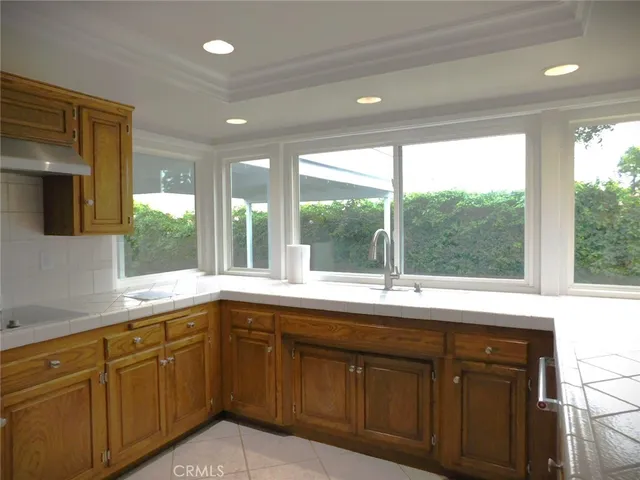 a open kitchen with sink window and cabinets