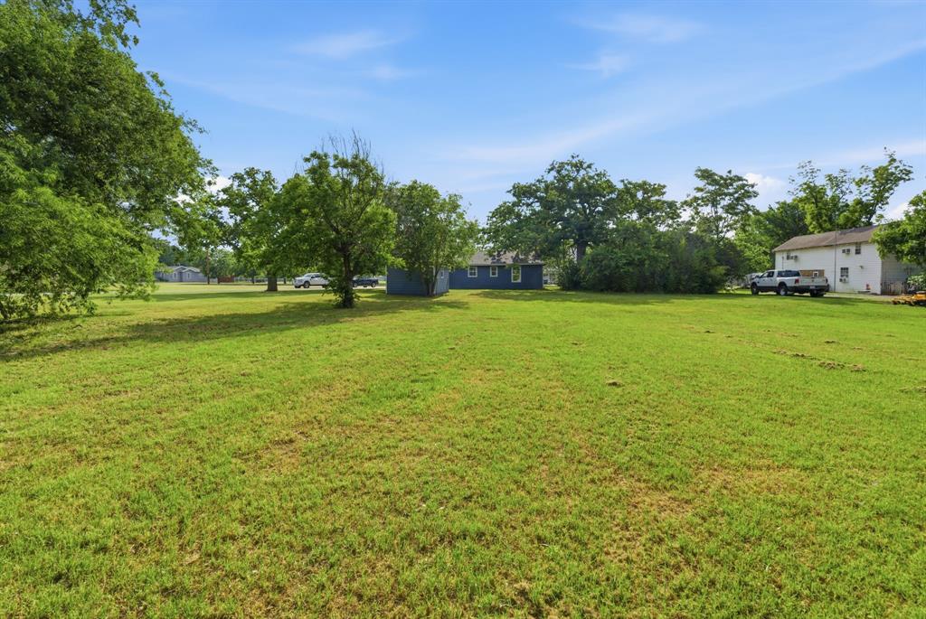 203 North Kickapoo Street Lipan, TX 76462 - Photo 25 of 28 a view of a field with an trees in the background