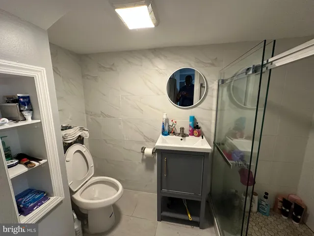 a bathroom with a toilet sink and mirror