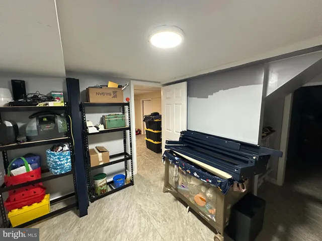 a room with lots of books and furniture