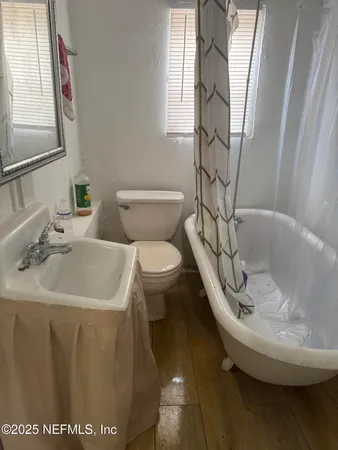 a bathroom with a sink toilet and mirror