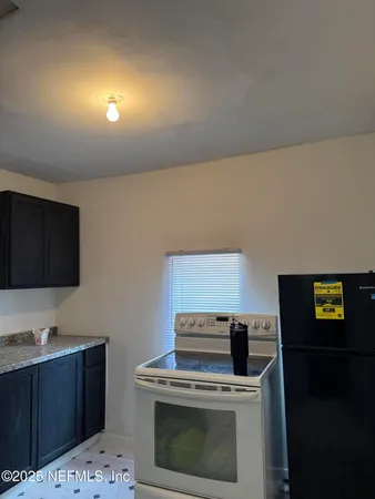 a kitchen with a stove and a microwave