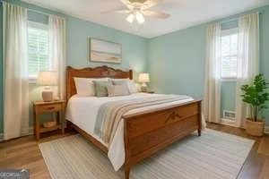 a bedroom with bed and a potted plant