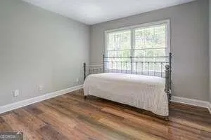 a bed sitting in a bedroom next to a window
