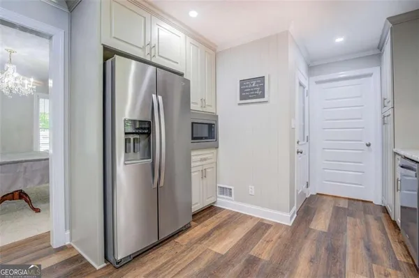 a view of kitchen with refrigerator and window