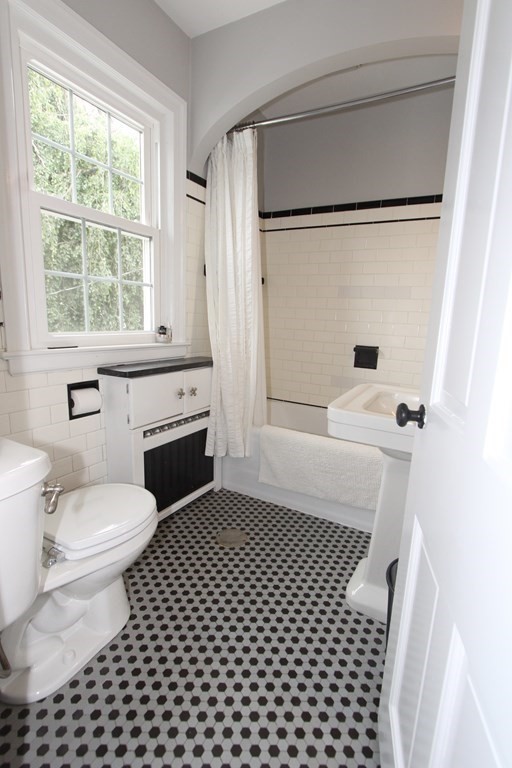 16 Thorndyke Road Worcester, MA 01606 - Photo 12 of 17 a bathroom with a sink a toilet a window and a shower