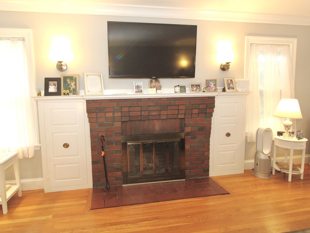 16 Thorndyke Road Worcester, MA 01606 - Photo 4 of 17 a living room with a fireplace and a flat screen tv