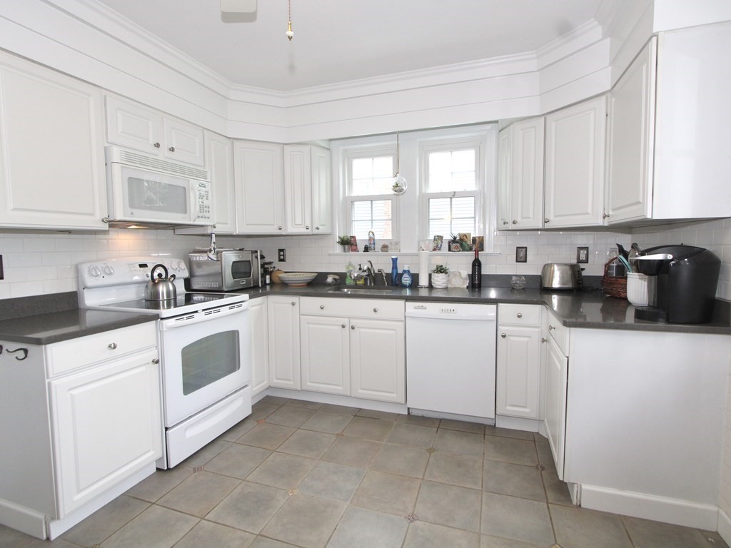 16 Thorndyke Road Worcester, MA 01606 - Photo 6 of 17 a kitchen with cabinets appliances a sink and a window