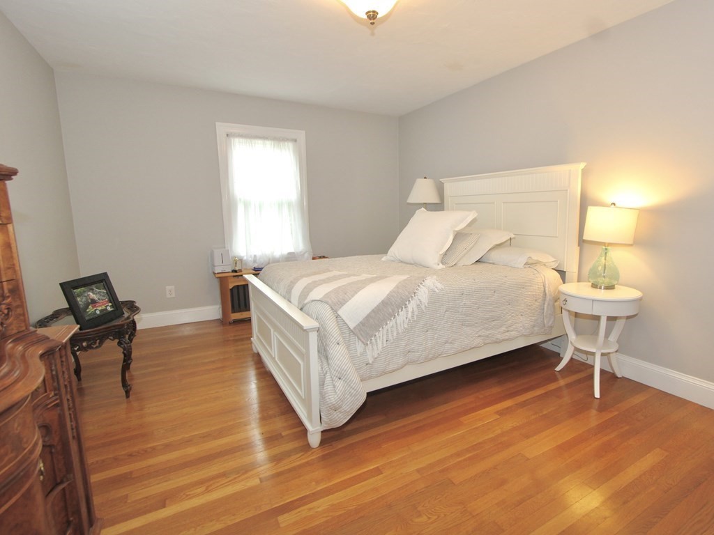 16 Thorndyke Road Worcester, MA 01606 - Photo 9 of 17 a bedroom with a bed and a chair
