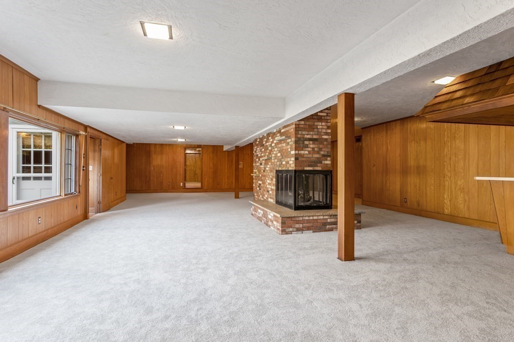 263 Lincoln Road Lincoln, MA 01773 - Photo 25 of 37 a view of an empty room with a fireplace and a window