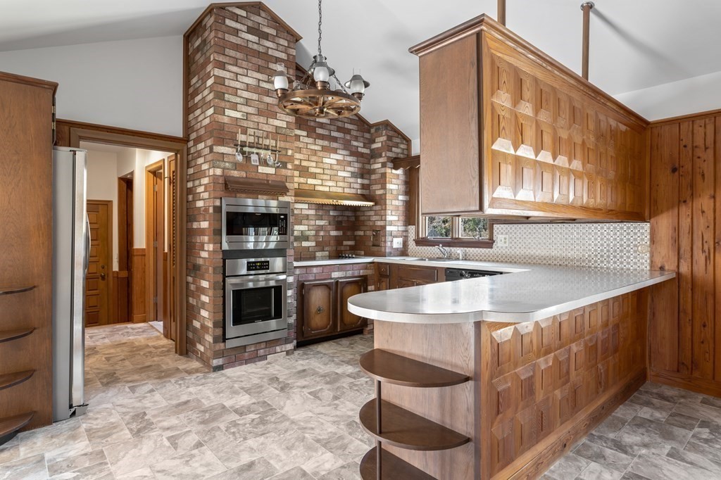 263 Lincoln Road Lincoln, MA 01773 - Photo 7 of 37 a kitchen with stainless steel appliances granite countertop a sink and a refrigerator