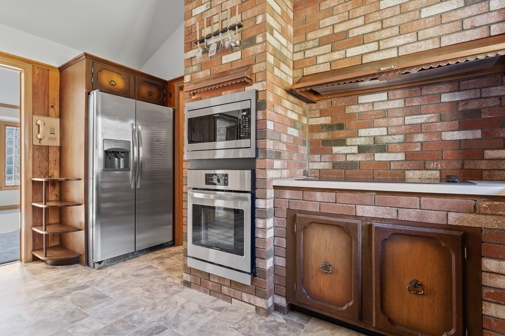 263 Lincoln Road Lincoln, MA 01773 - Photo 8 of 37 a kitchen with stainless steel appliances granite countertop a stove and a refrigerator