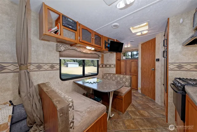a dinning room with furniture and window