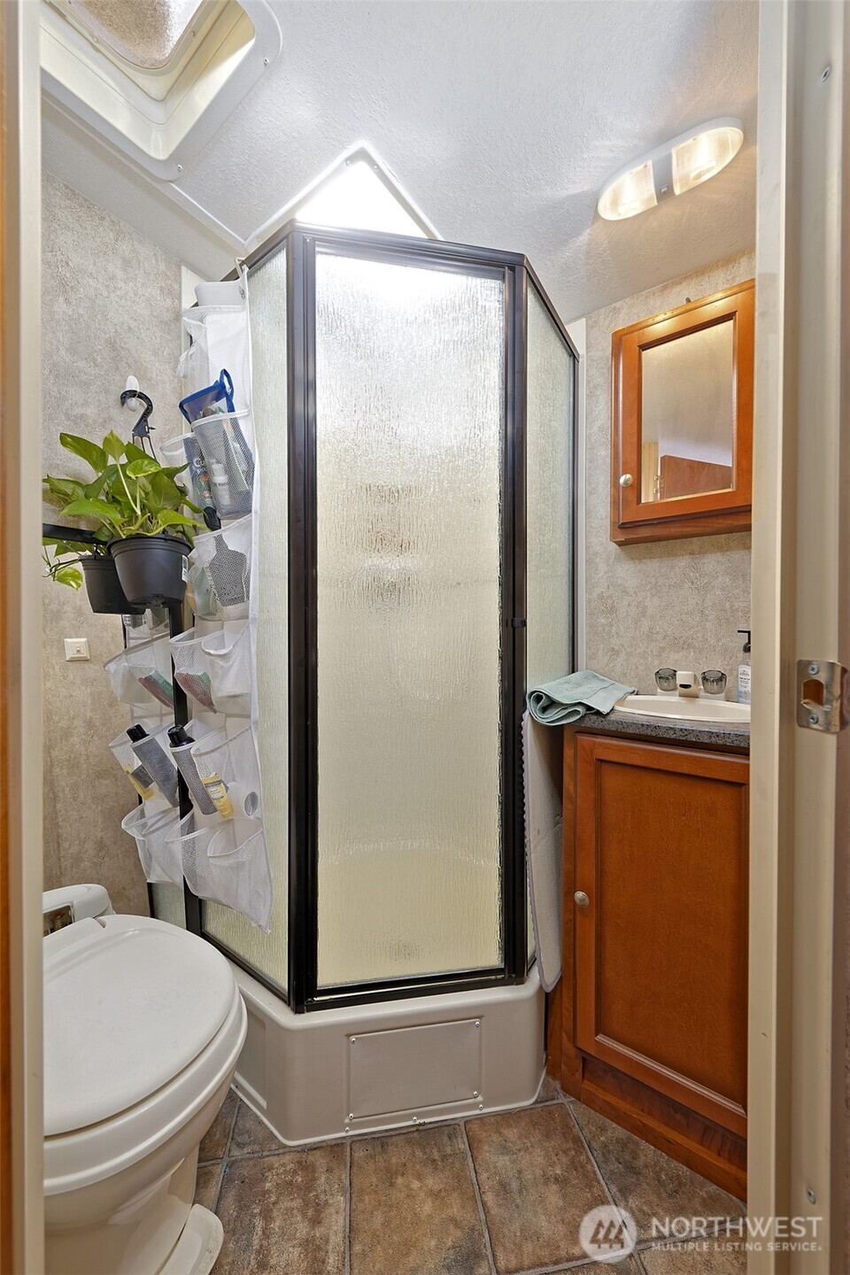 1982 West Ford Loop Road Elma, WA 98541 - Photo 18 of 29 a bathroom with a granite countertop sink a toilet and shower