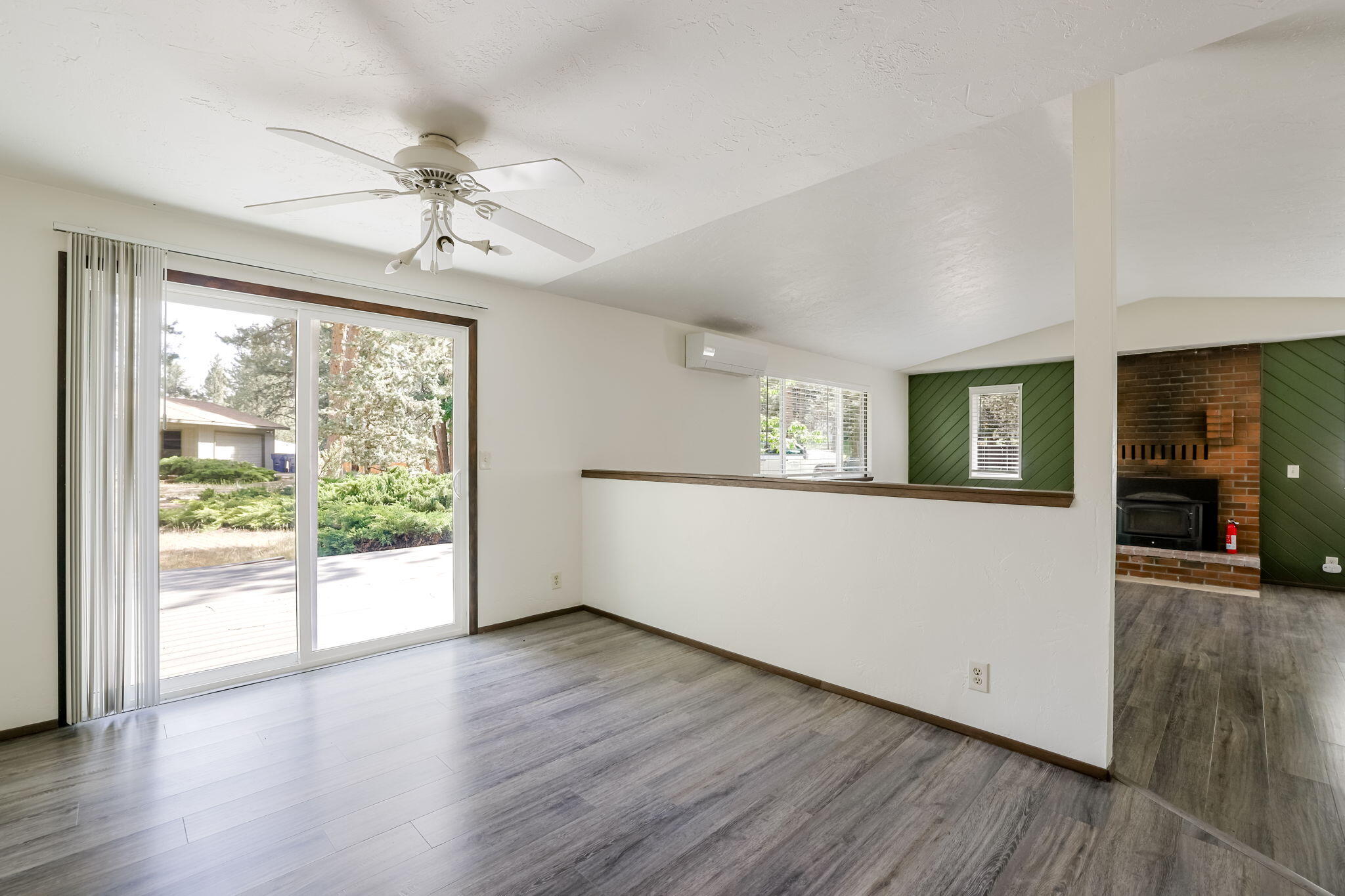 19968 Double Tree Court Bend, OR 97702 - Photo 7 of 28 a view of an empty room with wooden floor and a window