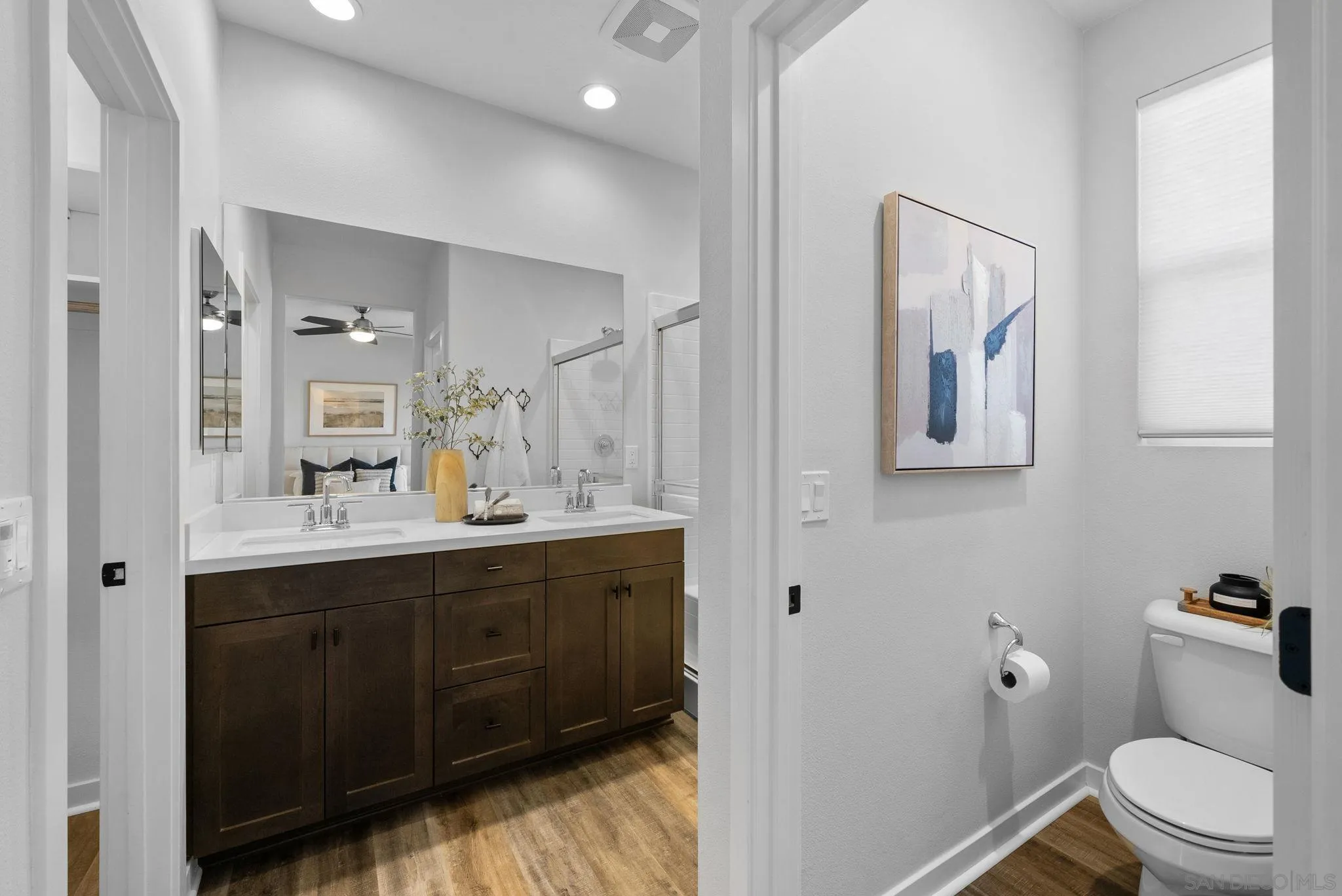 4229 Mission Ranch Way Oceanside, CA 92057 - Photo 12 of 26 a bathroom with a toilet a sink a mirror and vanity
