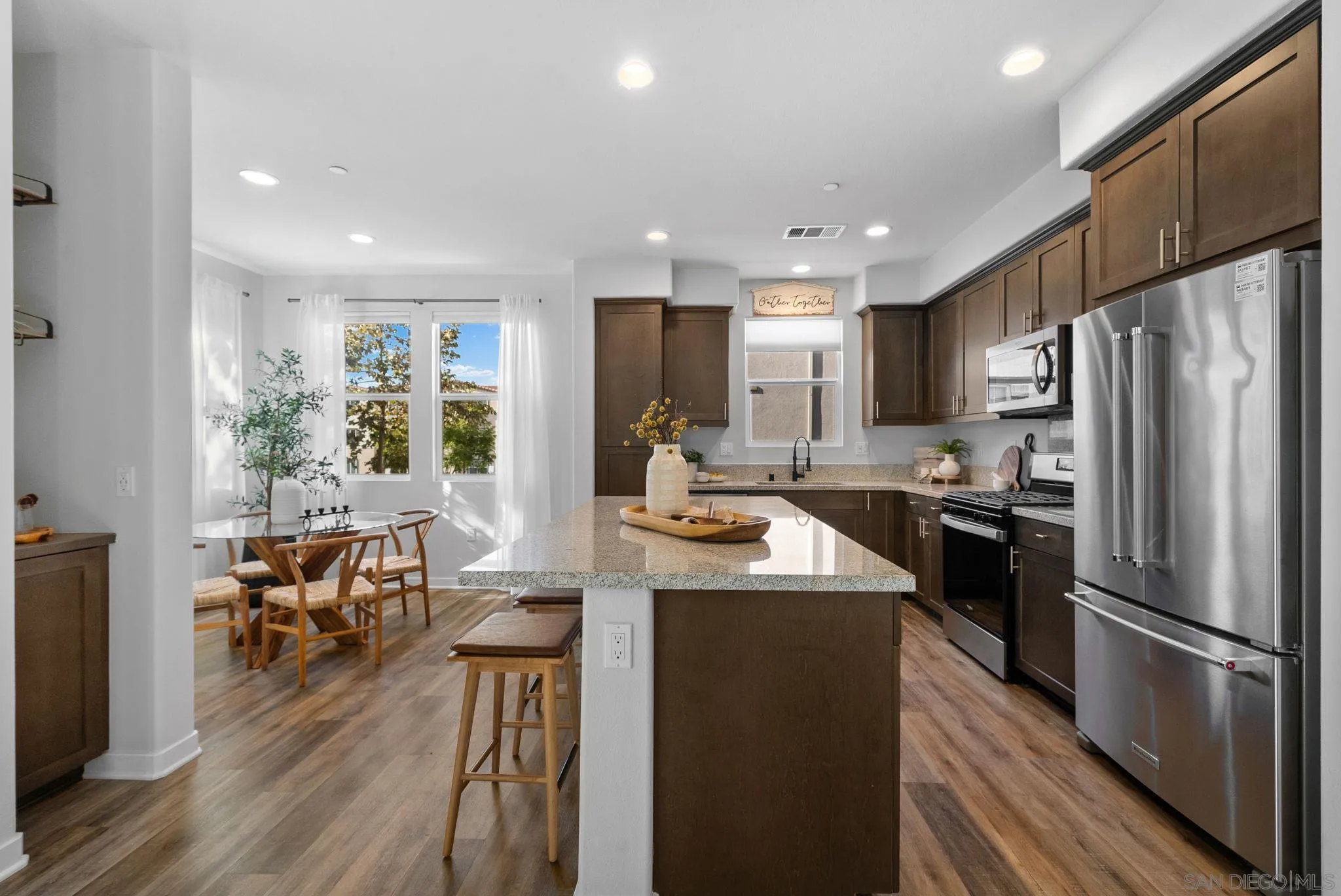 4229 Mission Ranch Way Oceanside, CA 92057 - Photo 5 of 26 a kitchen with stainless steel appliances granite countertop a refrigerator stove microwave and cabinets