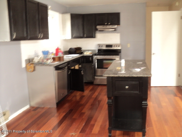1037 Decker Road Bushkill, PA 18324 - Photo 2 of 8 a kitchen with granite countertop a sink cabinets and stainless steel appliances