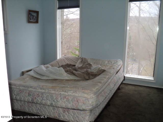 1037 Decker Road Bushkill, PA 18324 - Photo 3 of 8 a bedroom with a bed and window