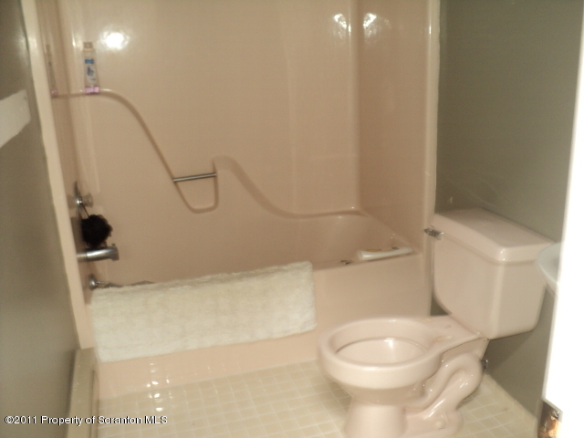 1037 Decker Road Bushkill, PA 18324 - Photo 5 of 8 a white toilet sitting next to a bath tub