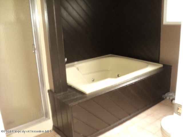 1037 Decker Road Bushkill, PA 18324 - Photo 6 of 8 a bathroom with a bathtub and shower