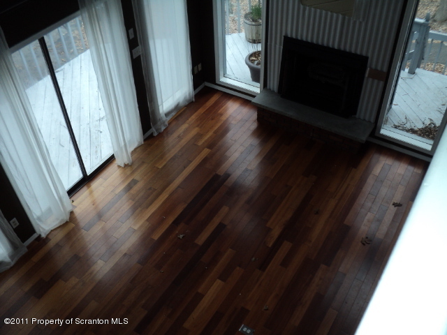 1037 Decker Road Bushkill, PA 18324 - Photo 7 of 8 a view of an empty room with wooden floor and a window