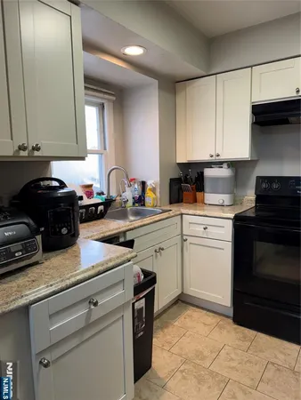 a kitchen with a sink stove and cabinets