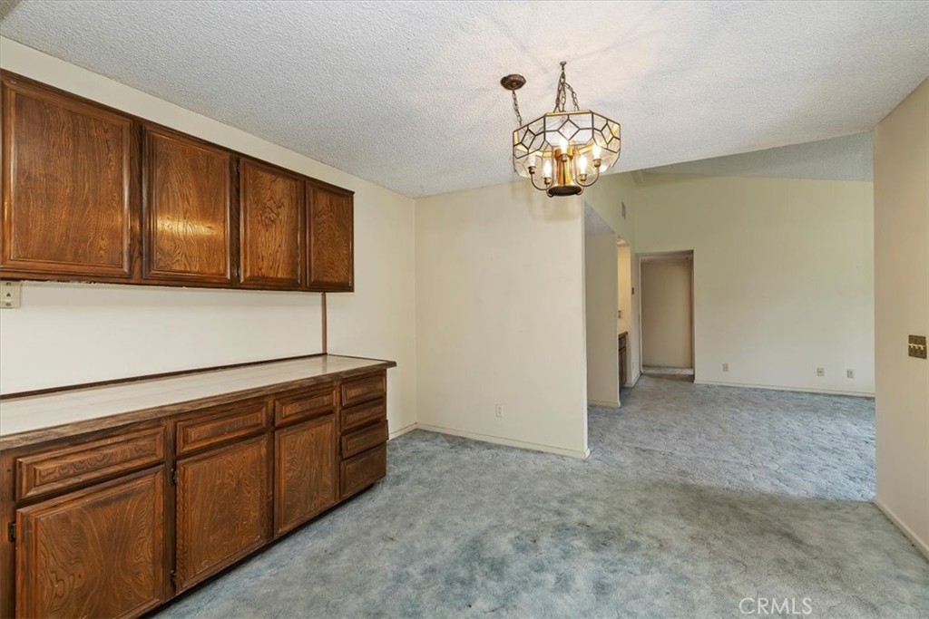 1825 Flame Tree Way Hemet, CA 92545 - Photo 11 of 23 a view of a kitchen with a microwave and cabinets
