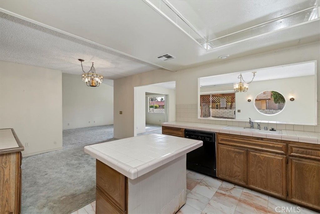 1825 Flame Tree Way Hemet, CA 92545 - Photo 14 of 23 a kitchen with a sink a stove and microwave