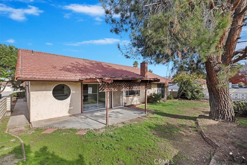 1825 Flame Tree Way Hemet, CA 92545 - Photo 23 of 23 a front view of a house with a yard and garage