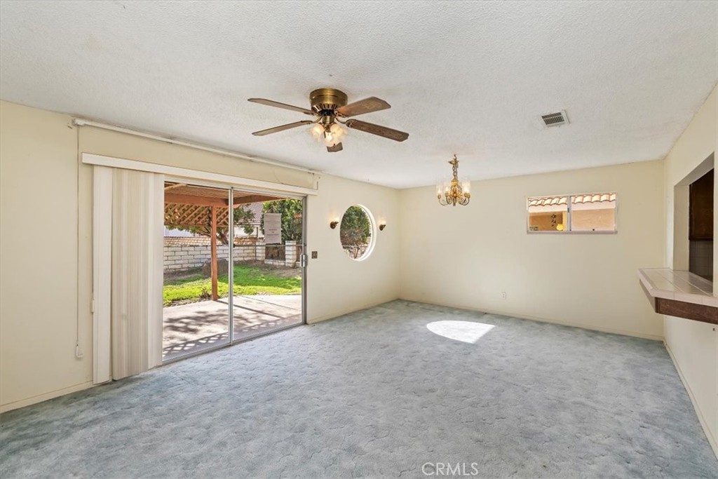 1825 Flame Tree Way Hemet, CA 92545 - Photo 9 of 23 a view of an empty room with a window