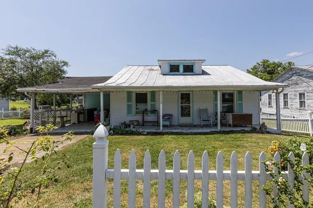 a view of a house with swimming pool and porch with furniture