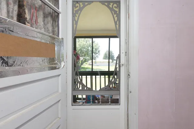 a view of an empty room and bathroom