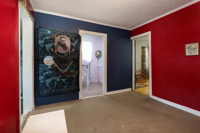 a bedroom with a bed and a chair