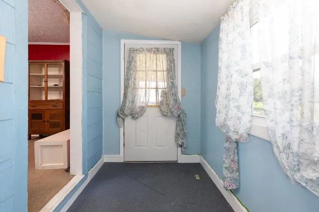 a front view of house with swimming pool and furniture