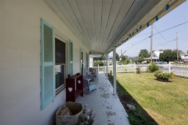 a view of a house with a yard and floor to ceiling window