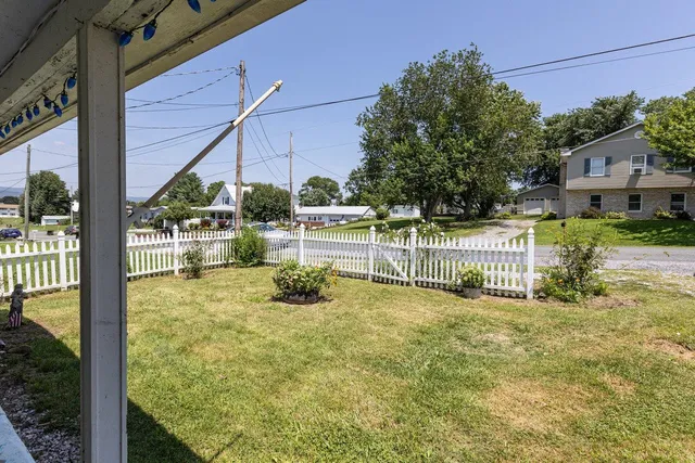 a backyard of a house with table and chairs
