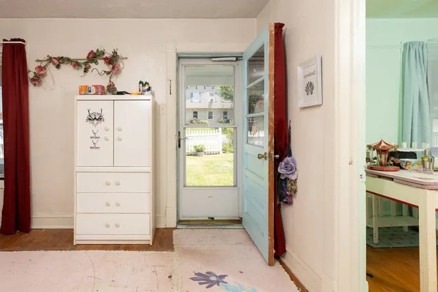 a view of a bedroom with window and cabinet