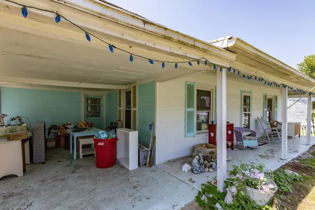 a view of a house with a yard patio and furniture