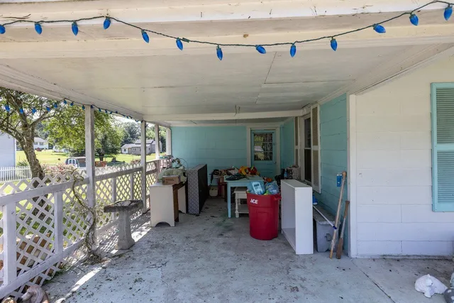 an aerial view of a house with swimming pool and large trees
