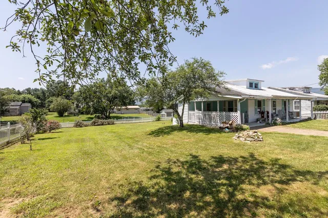 an aerial view of a house with a swimming pool