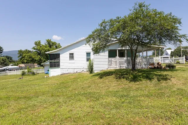 an aerial view of a residential houses with outdoor space