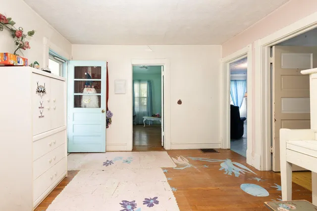 a room with gym equipment and view of living room