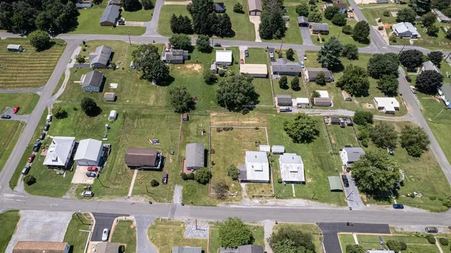 an aerial view of a residential apartment building with a yard