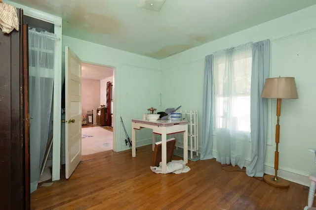 a view of hallway with closet and a window