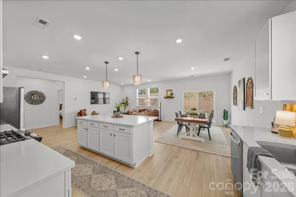 a large kitchen with a table and chairs in it