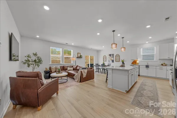 a living room with furniture and kitchen view