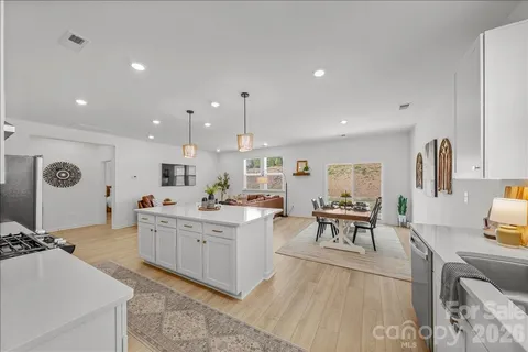 a large kitchen with a table and chairs in it
