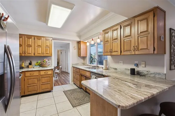 a kitchen with stainless steel appliances granite countertop a stove a sink and a refrigerator