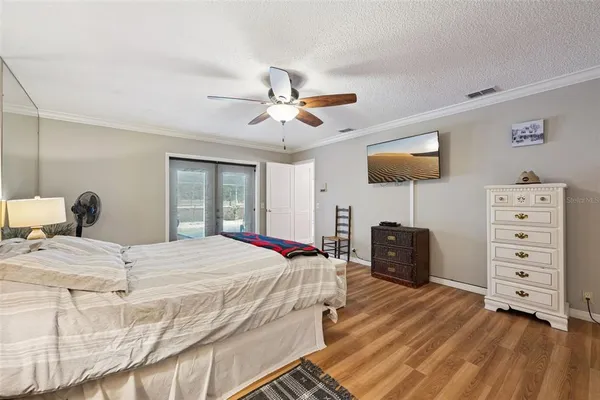 a bedroom with a bed and a ceiling fan